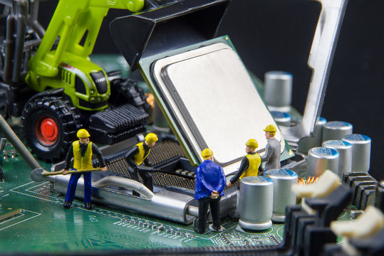 Tiny toys team of engineers repairing circuit mother board compu