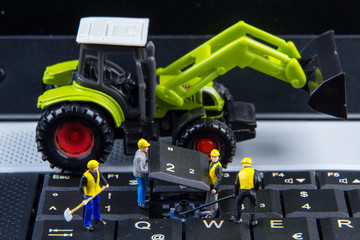 Tiny toys team of engineers repairing keyboard computer laptop.C