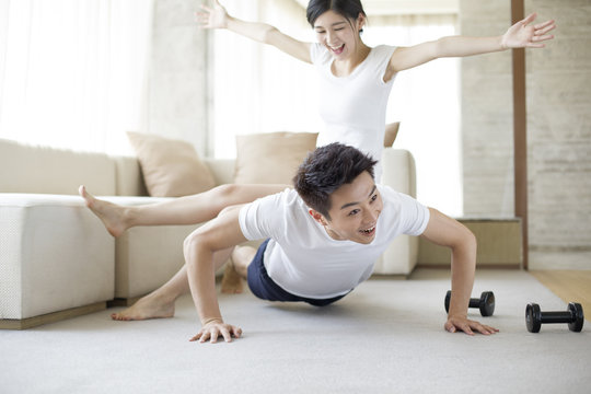 Young couple exercising at home