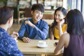 Young friends talking in cafe