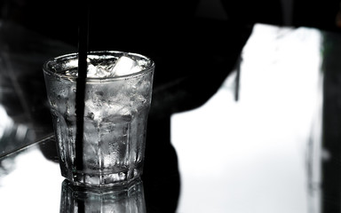 Iced water And condensation inside the glass in gray tone.