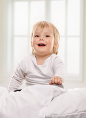 Fototapeta premium Happy baby girl child playing in bed