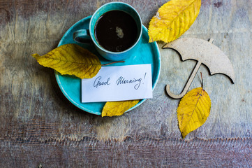 Cup of coffee with autumnal leaves