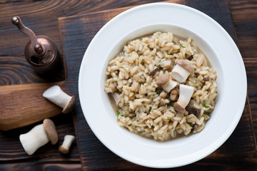 Above view of a glass plate with porcini risotto, close-up