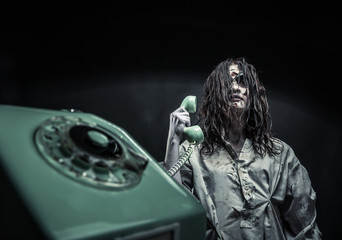 Horror zombie girl calling by phone