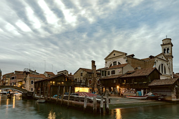 Fototapeta na wymiar San Trovaso, Venice - church and boatyard with dramatic sky in the evening