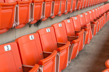 orange plastic seats in sport stadium