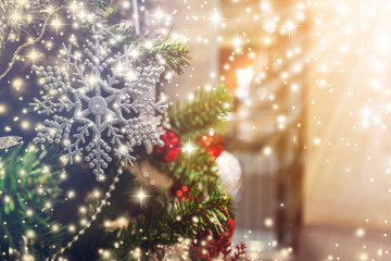 Closeup of Christmas-tree with decorations items in light and bokeh background with light flare...