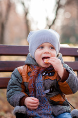 A child in the park eating Mandarin