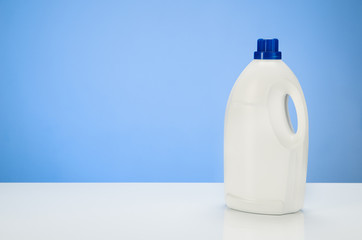 Cleaning or laundry product concept blue gradient background with accessories. Assorted products isolated on white and blue backdrop. Studio product shot for advertising, website or blog.