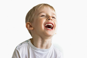 cheerful boy laughing showing white teeth, very soft focus