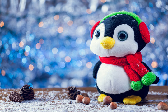Cute Happy Penguin Christmas Toy Smiling On Snowy Wood