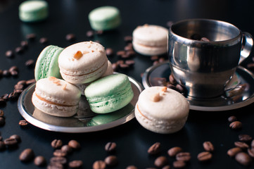 cup of coffe with french macaron on darck background.