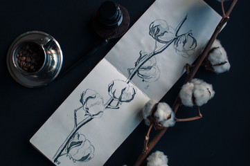 notebook, ink bottle, ink pen, dark background,dried cottonbrunch with flowers
