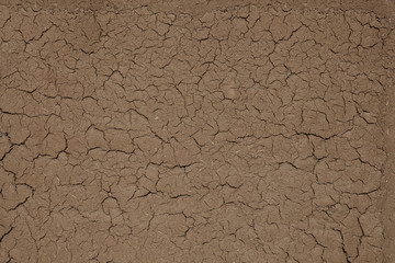 Abstract background in the form of the cracked clay wall