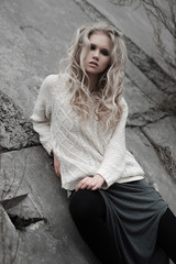 beautiful young  blonde woman with blue eyes in white pullover long skirt on spring background, forest, lake, trees. Cold mood. Fashion, emotional portrait..Winter, spring, outdoor portrait. 