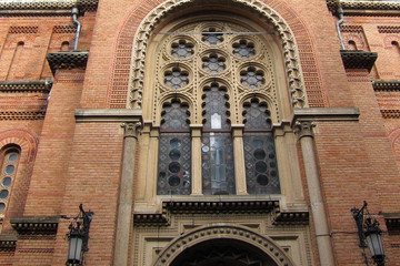 Fototapeta na wymiar Brick red wall with a window in the Gothic style