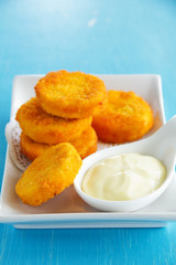 Homemade chicken nuggets with sauce.