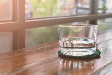 Glasses of water on a wooden table. Selective focus. Shallow DOF