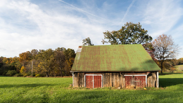 old abandoned barn with red doors and a green roof in Virginia