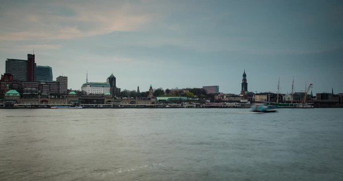 Hamburg, Germany - view over river Elbe with ships from south shore to Landungsbruecken, church Michel and ship Rickmer Rickmers at colorful sunset - Timelapse without motion - April 2016