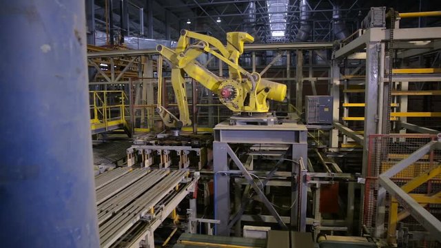 Industrial robot. Robotic arm assembling products on a modern plant. HD.