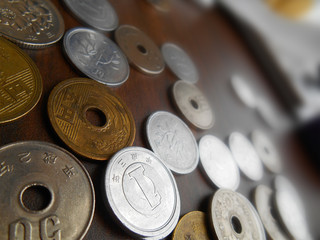 A Bunch of Coin Money Japanese Yen Currency on Brown Table.