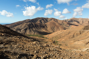 Beautiful volcanic mountains and the road on a mountain slope.  Road from la Pared to Betancuria . Fuerteventura. Canary Islands