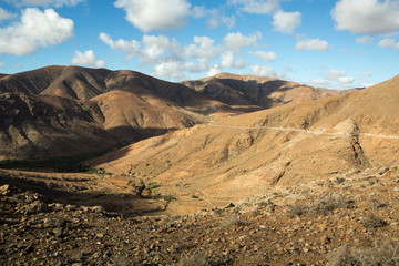 Beautiful volcanic mountains and the road on a mountain slope.  Road from la Pared to Betancuria . Fuerteventura. Canary Islands