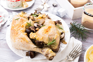 Delicious Christmas themed dinner table with roasted chicken, appetizers and desserts. Holiday concept.
