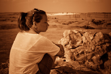 Girl on a hill in the desert. Ordinary people. Effect - Sepia.