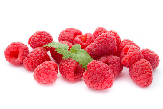Ripe raspberry with leaf isolated on the white background.