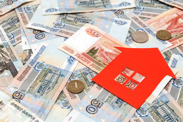 Fototapeta premium Red paper house and a lot of Russian money