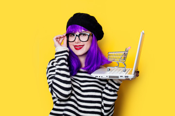 woman with shopping cart and laptop