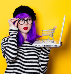woman with shopping cart and laptop © Masson