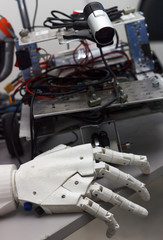 Close up of robot hand on table with details at background