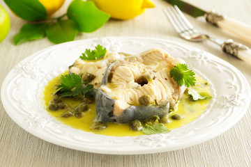 Hot lunch vapor sturgeon with lemon sauce and capers.