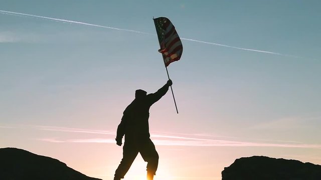 Soldier and American Flag Against Sunrise Sky. Slow Motion 