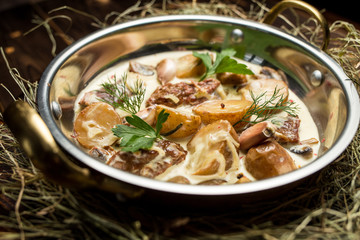 potatoes with chunks of meat in a creamy sauce