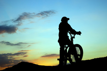 Obraz premium Biker at sunset