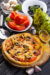 Delicious Homemade pizza served on wooden table