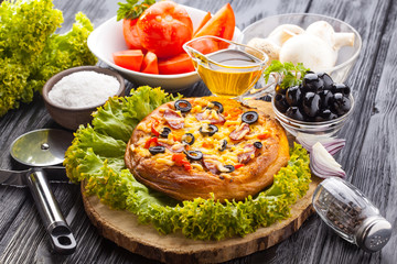 Delicious Homemade pizza served on wooden table