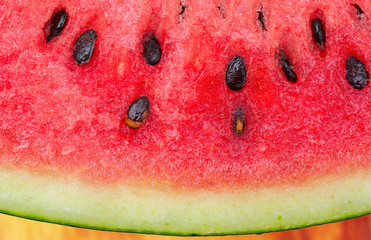 Watermelon and its seeds with Huge magnified macro shot and close up shot on wood table