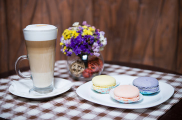 macaron on the white plate and cappuccino