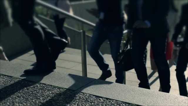 Businessmen crowd on the way to work in the morning. Concept for finance, business, job and economy. Modern buildings in business district. Action by day. Focus blur. Toned