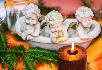 Advent candle with three angels and fir sprigs