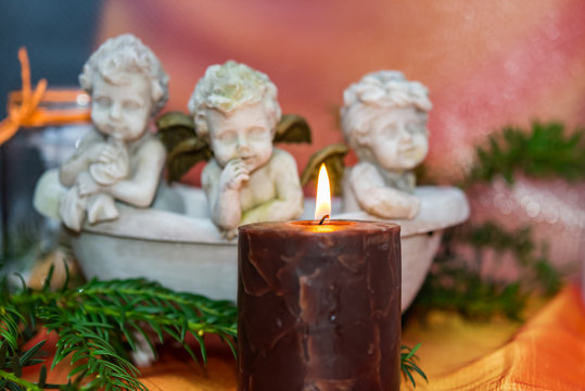 Advent candle with three angels and fir sprigs
