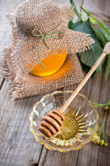 Linden honey on jar  on the  wooden table