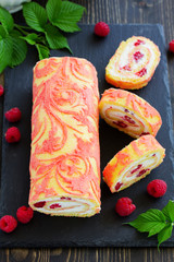 Sponge roulade with raspberries and cream.