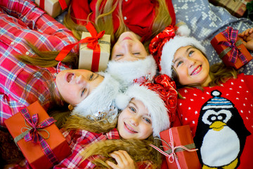 Fototapeta na wymiar Group of kids in red hat with Christmas gifts